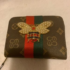 Inspired wallet with a bee on the front.